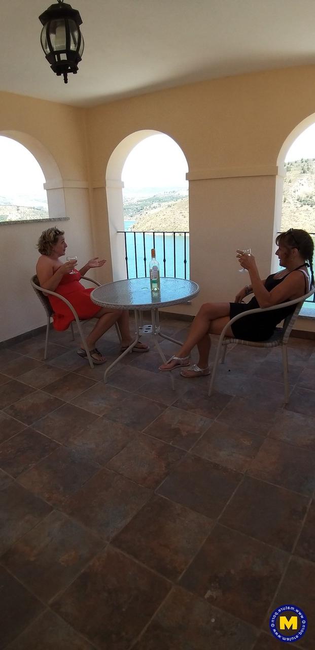 20P Curvaceous mature lesbians Camilla C & Pandora drinking wine on vacation