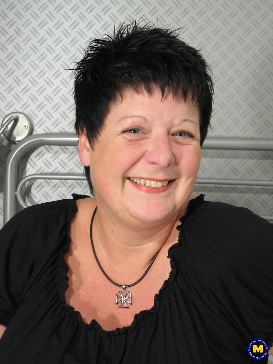 20P Busty short haired mature Fabienne lets out her melons and toys herself