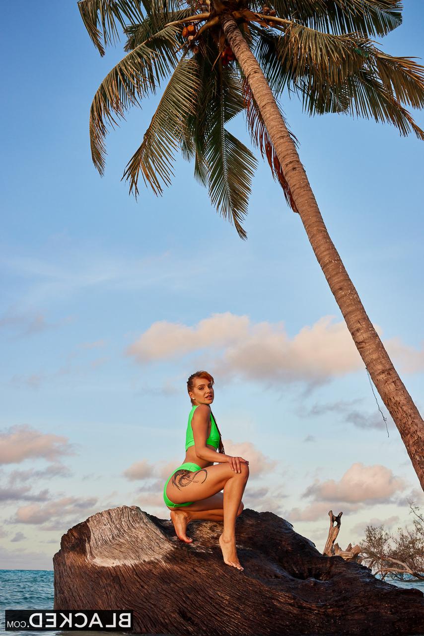 18P Attractive ginger Little Dragon sucks and rides a BBC on a sandy beach
