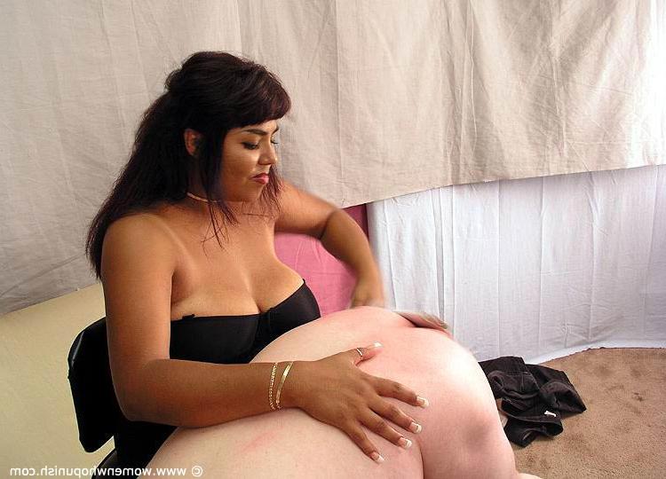 15P Brunette dominatrix takes a naked man over her knee before a harsh spanking
