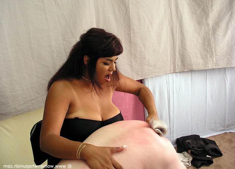 15P Brunette dominatrix takes a naked man over her knee before a harsh spanking