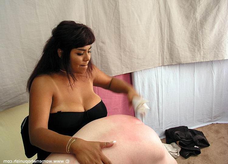 15P Brunette dominatrix takes a naked man over her knee before a harsh spanking