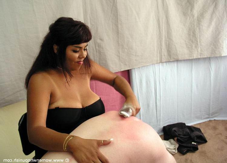 15P Brunette dominatrix takes a naked man over her knee before a harsh spanking