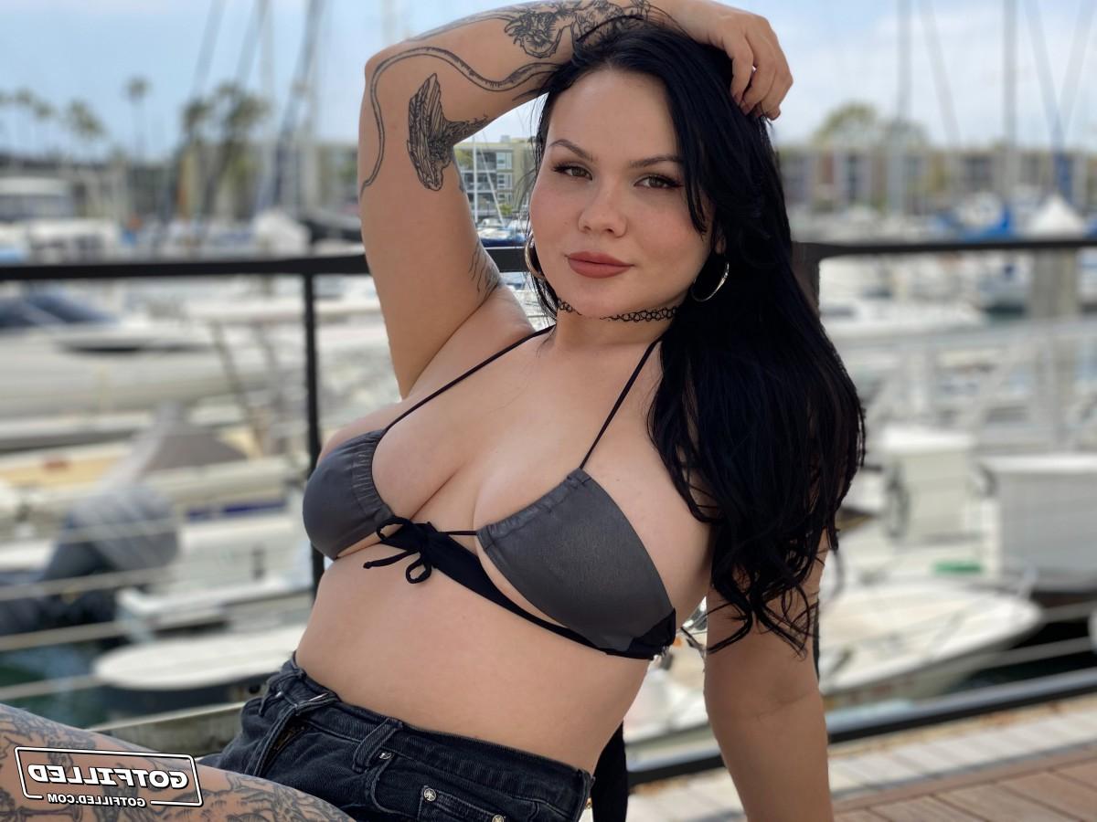 20P Tattooed brunette Brynn Michaels models a bikini at a marina before having sex