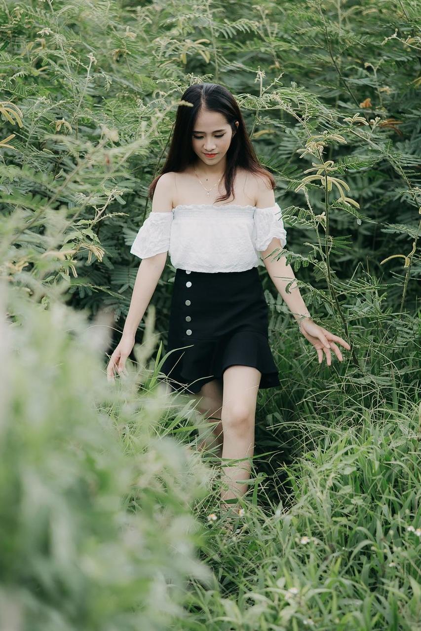20P Innocent Asian model posing in her top, skirt and shoes outdoors