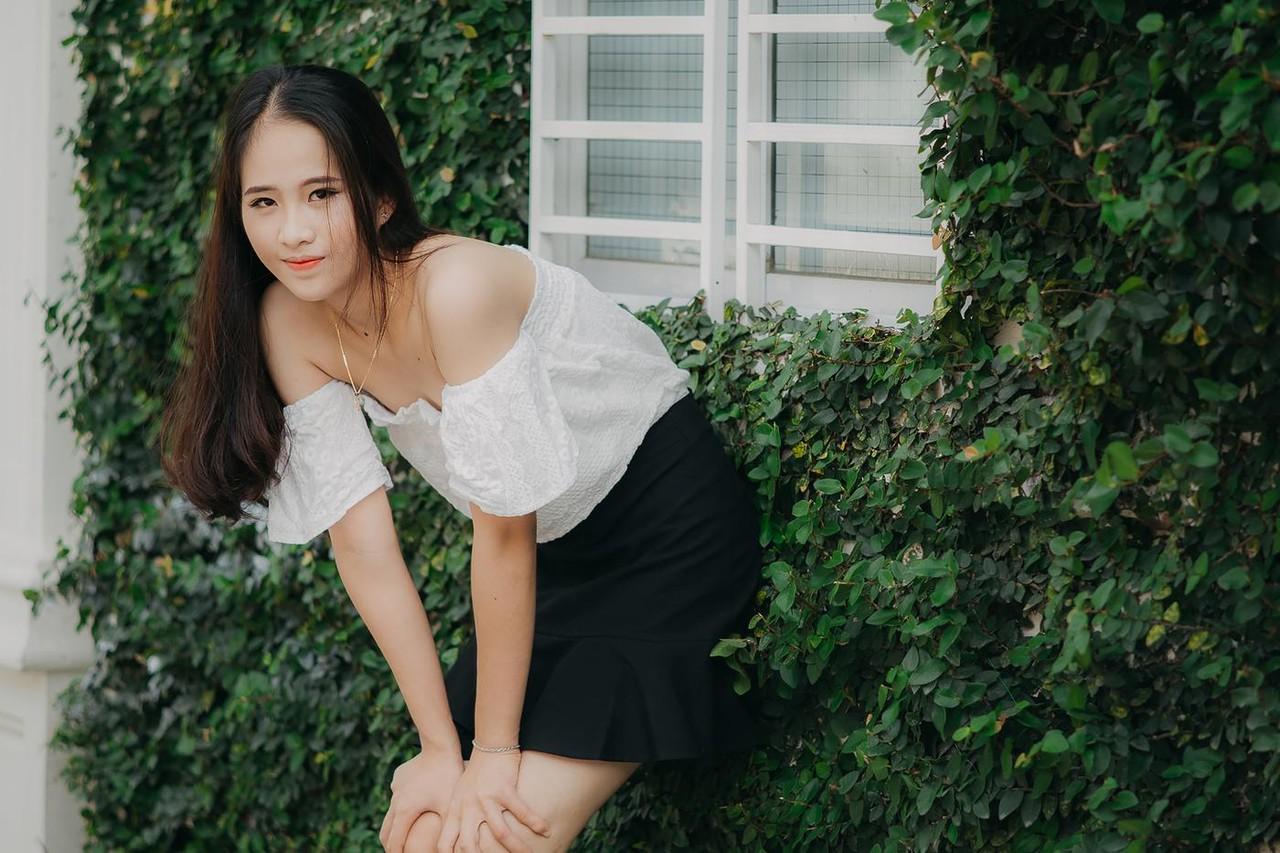 20P Innocent Asian model posing in her top, skirt and shoes outdoors