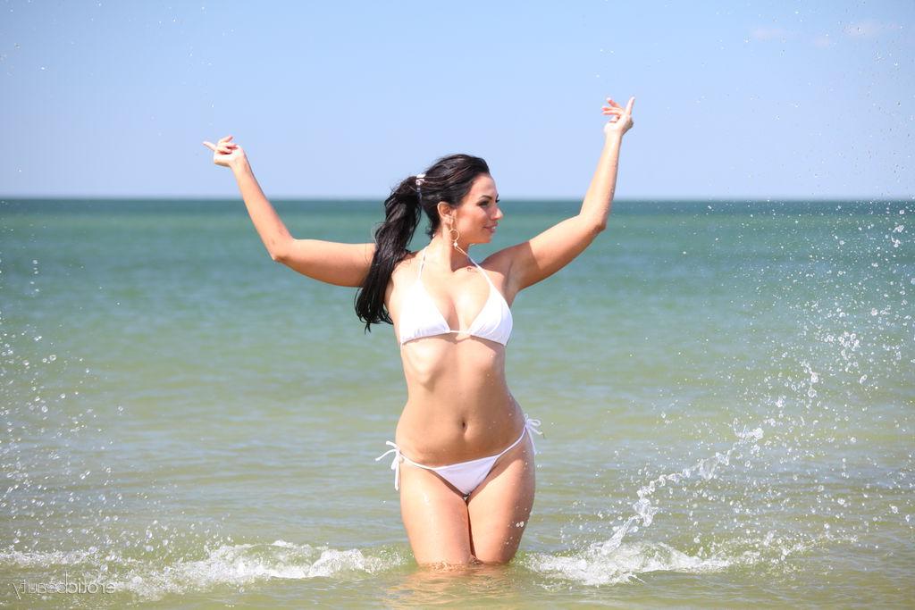 16P Gorgeous brunette Lusee takes off a bikini to get naked at the beach