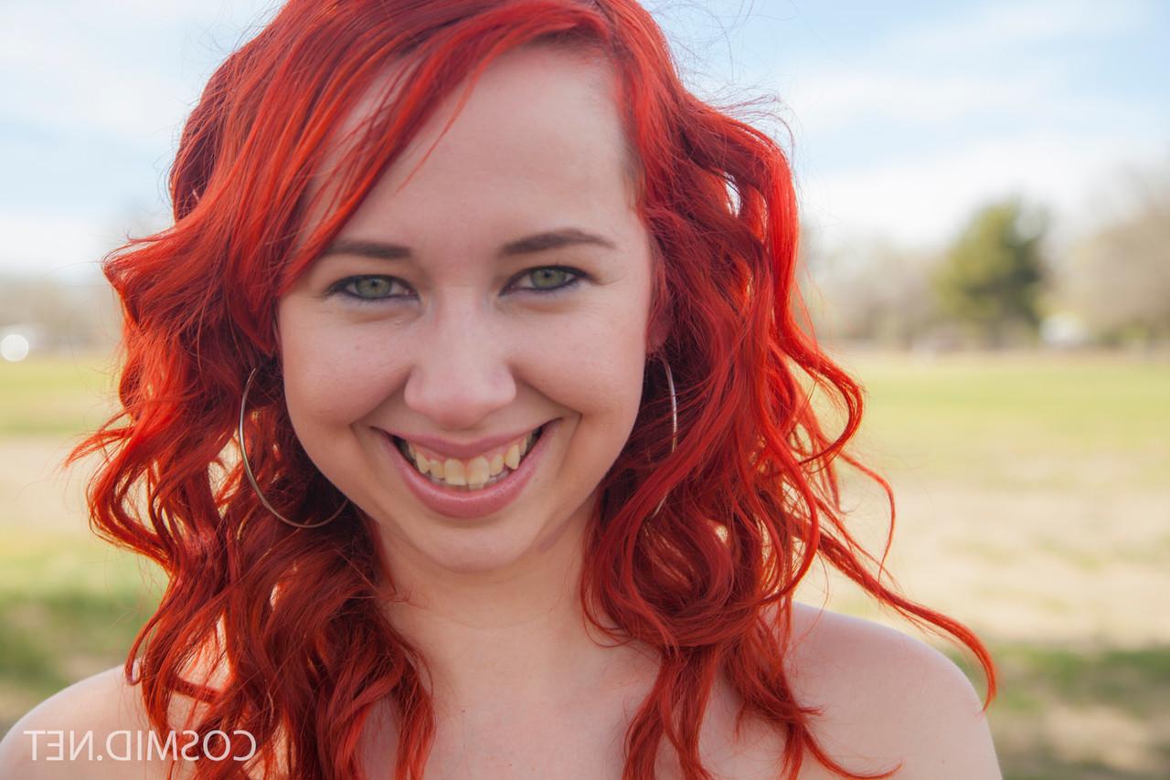 16P Plump redhead Alisyn Carliene bares her natural tits and twat on picnic table