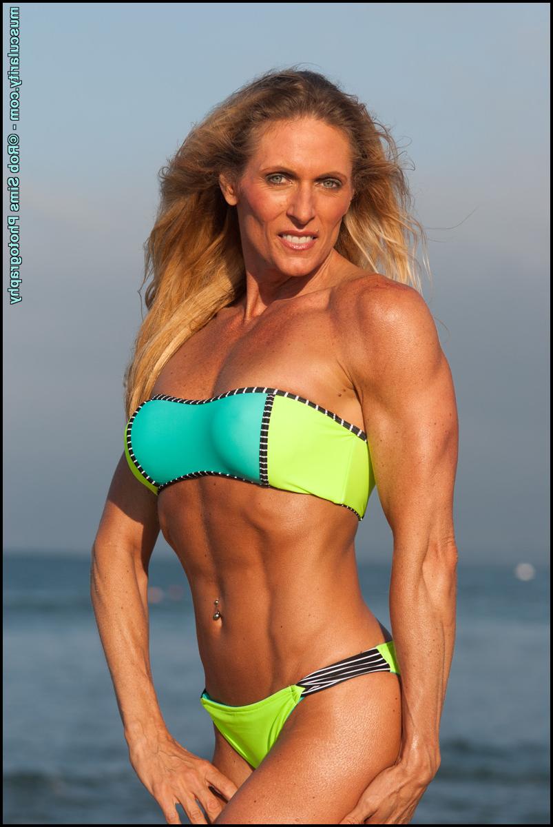 15P Female bodybuilder Kimberly Dickson poses in a bikini while at the beach