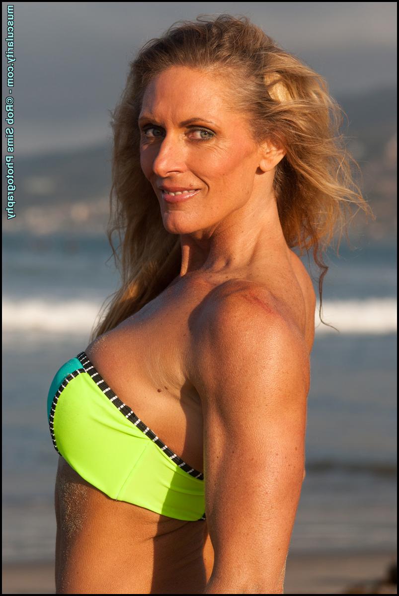 15P Female bodybuilder Kimberly Dickson poses in a bikini while at the beach