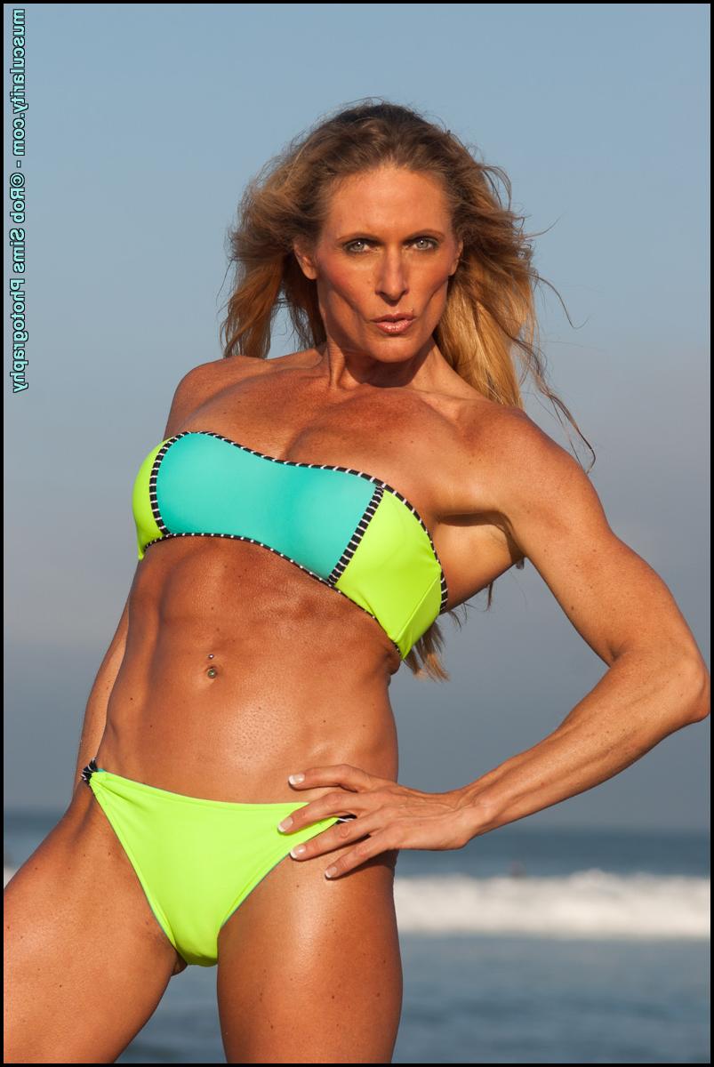 15P Female bodybuilder Kimberly Dickson poses in a bikini while at the beach