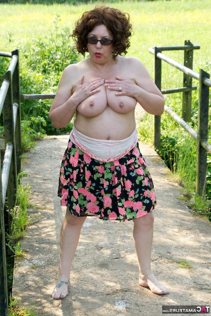 16P Mature fatty Dirty Doctor goes topless in a field while wearing sunglasses