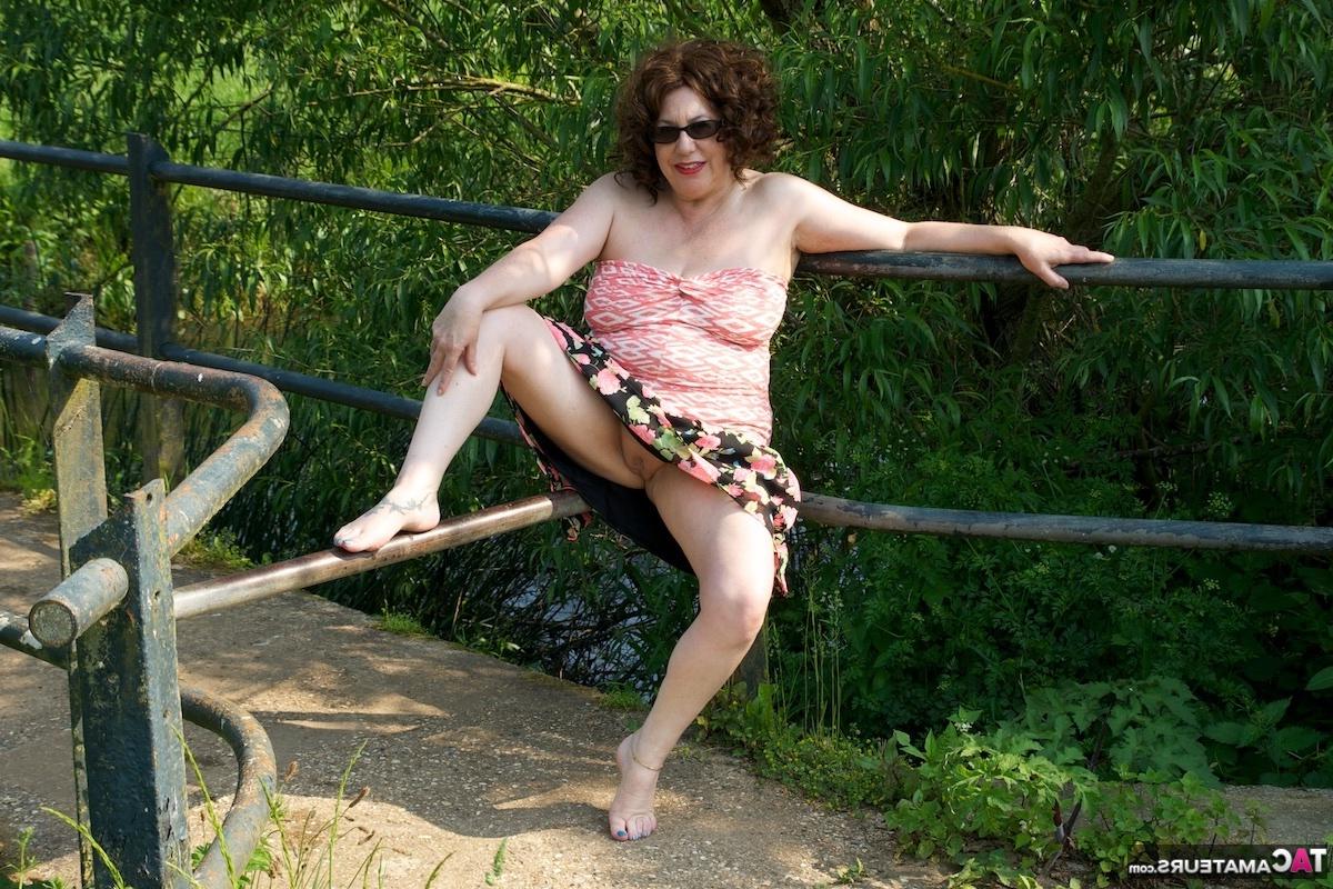 16P Mature fatty Dirty Doctor goes topless in a field while wearing sunglasses