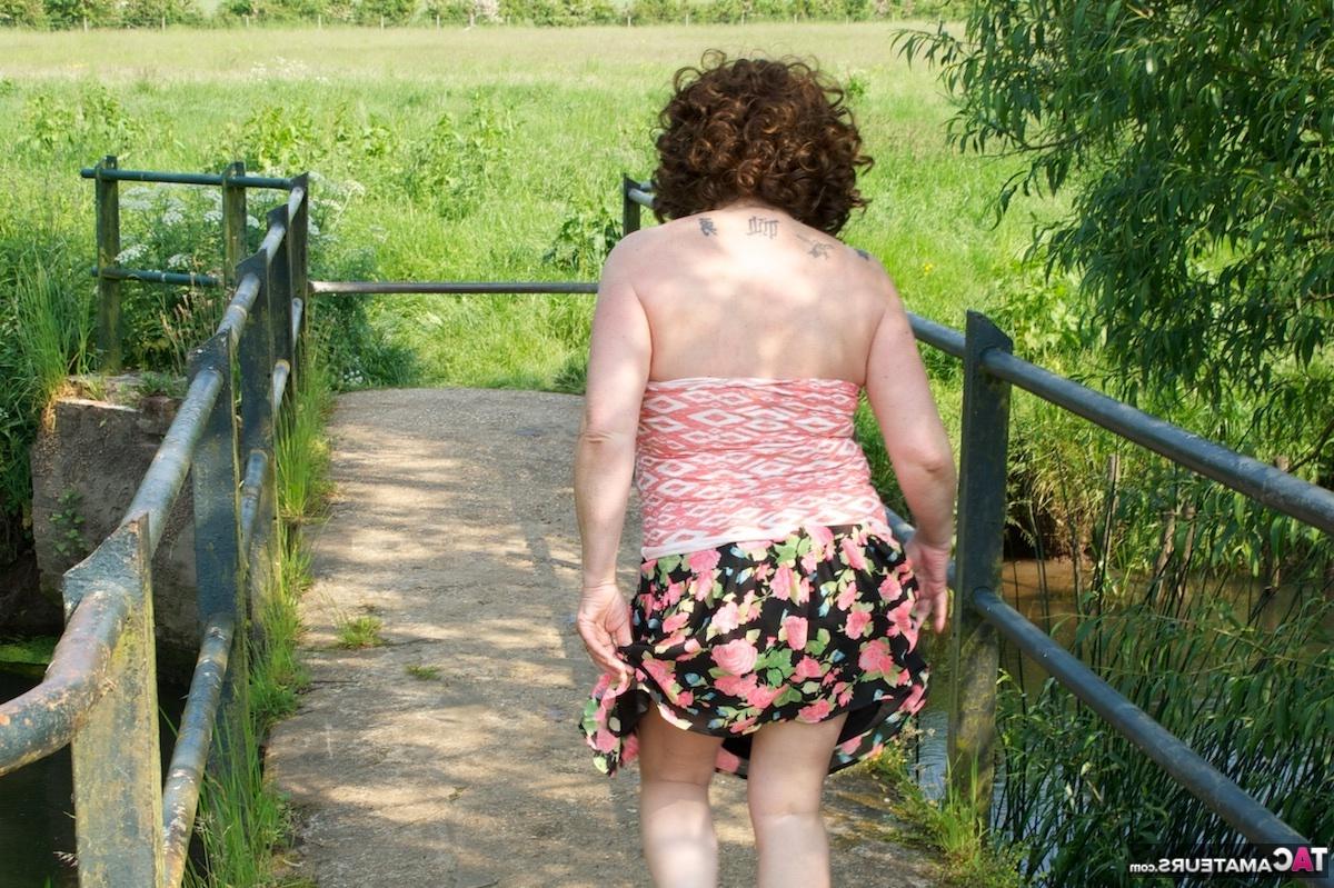 16P Mature fatty Dirty Doctor goes topless in a field while wearing sunglasses