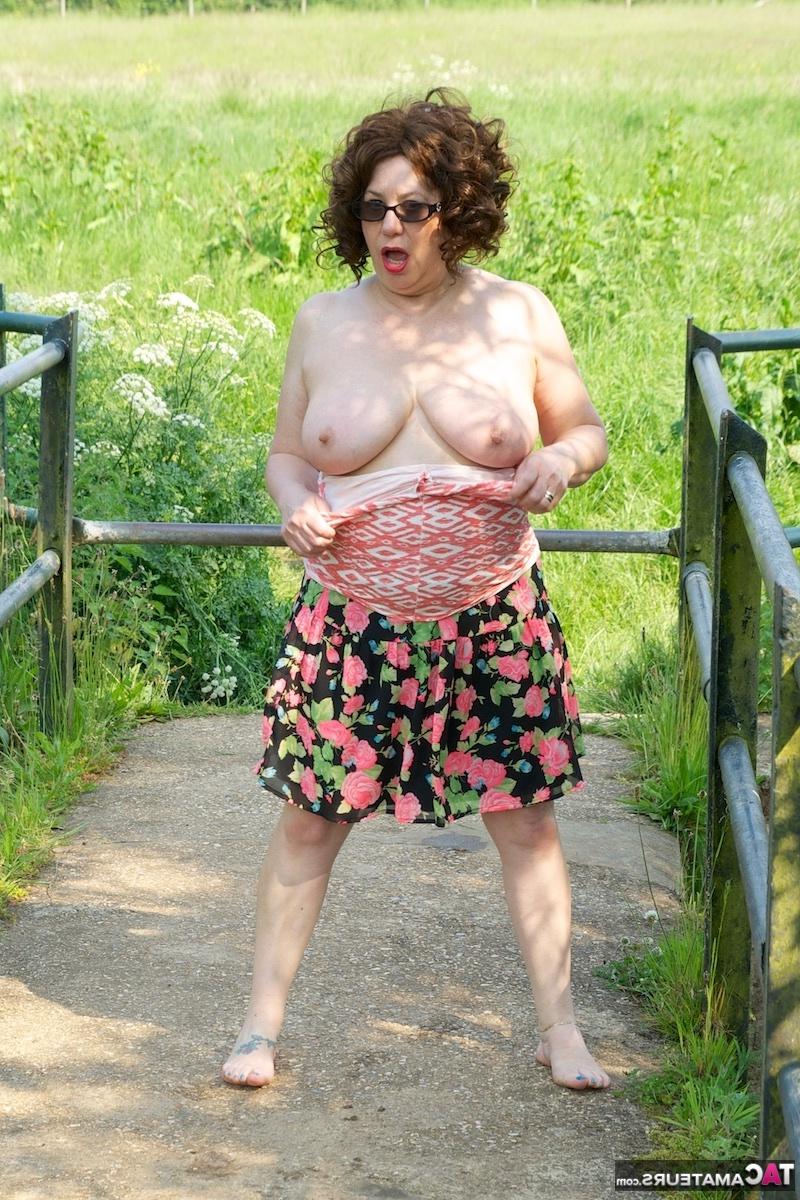 16P Mature fatty Dirty Doctor goes topless in a field while wearing sunglasses