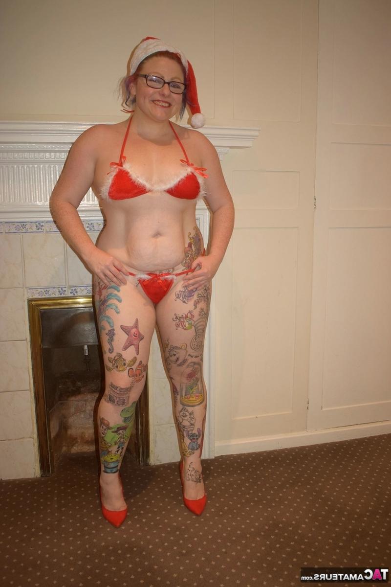 16P Mulher mais velha tatuada descarta pose de biquíni nua com boné de Papai Noel
