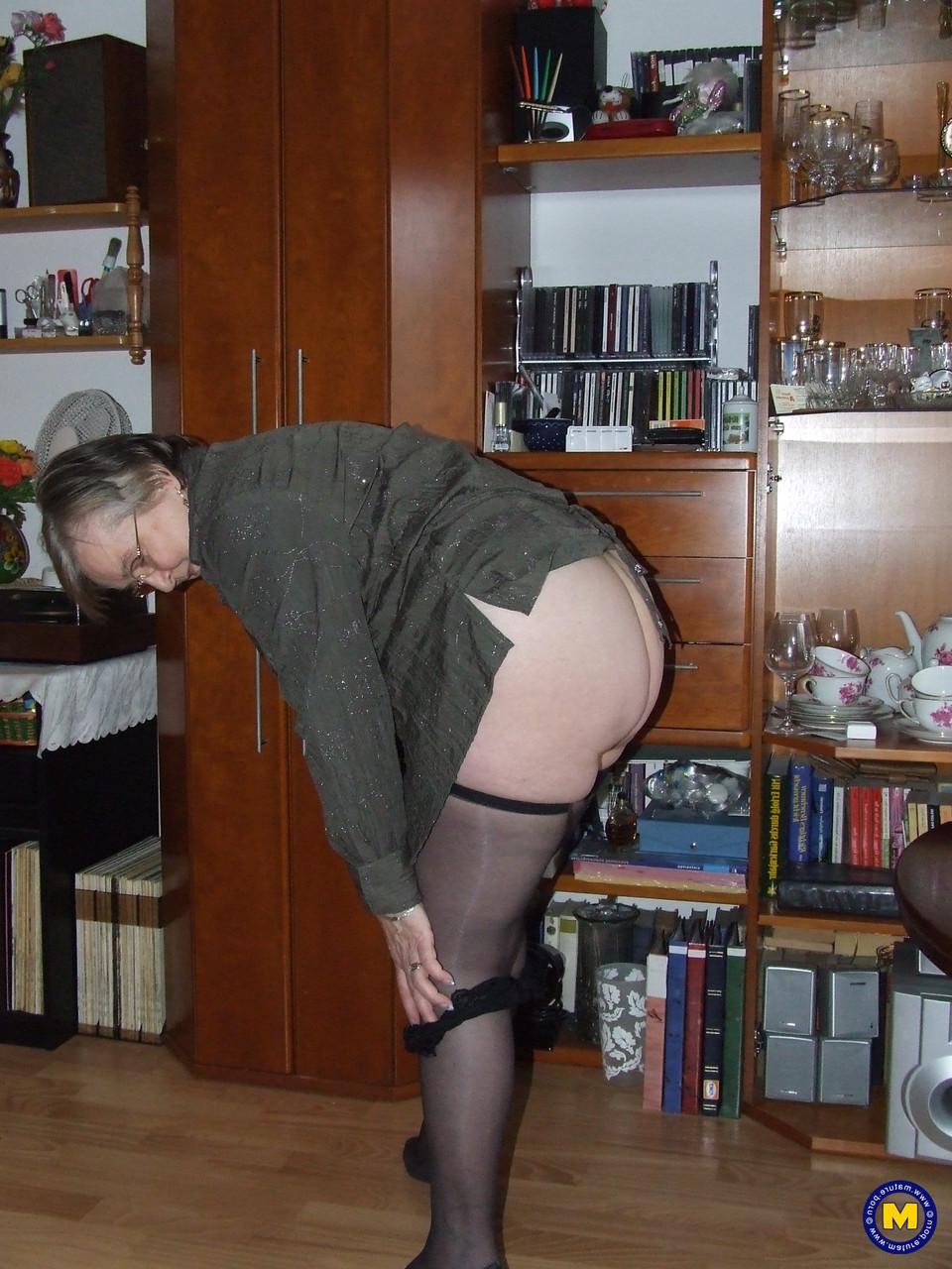 20P Chubby granny with glasses Sybille stripping naked & toying her fat pussy