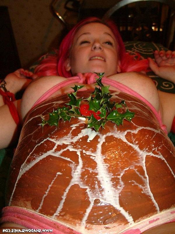 12P La chica embarazada tiene su barriga decorada con comida en una mesa