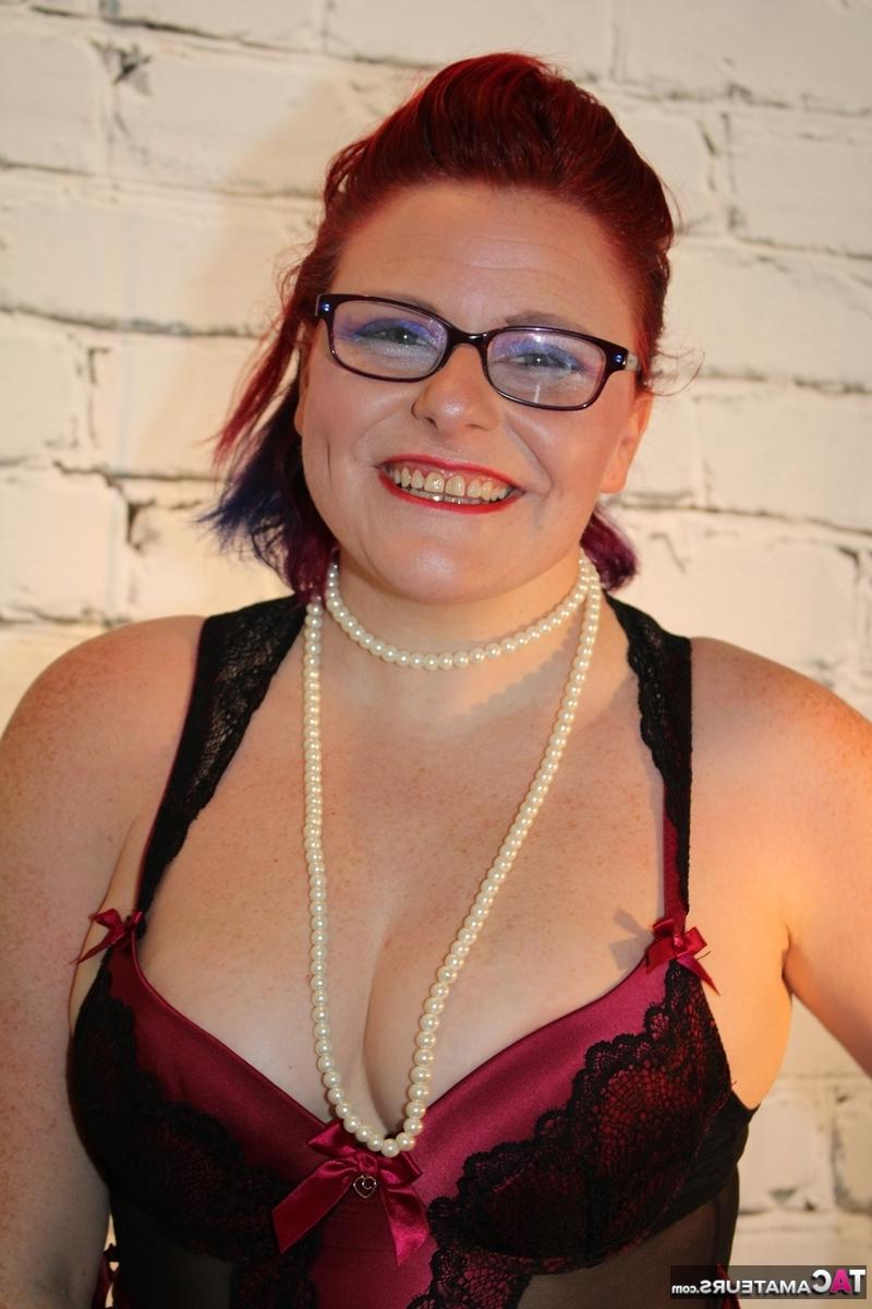 16P Chubby redhead looses her tits from lingerie while wearing glasses and nylons