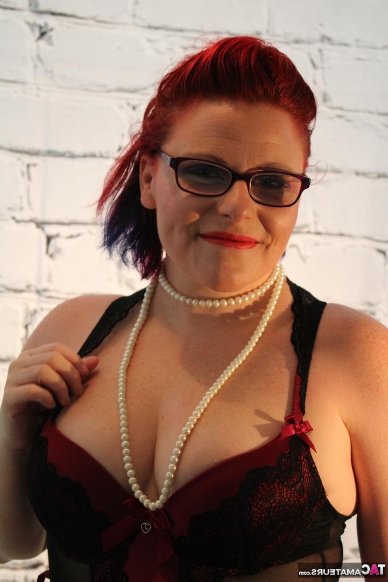 16P Chubby redhead looses her tits from lingerie while wearing glasses and nylons