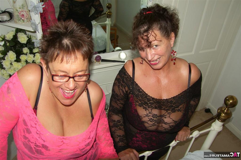 20P Old lesbians hump each on a bed while fully clothed and waving fans