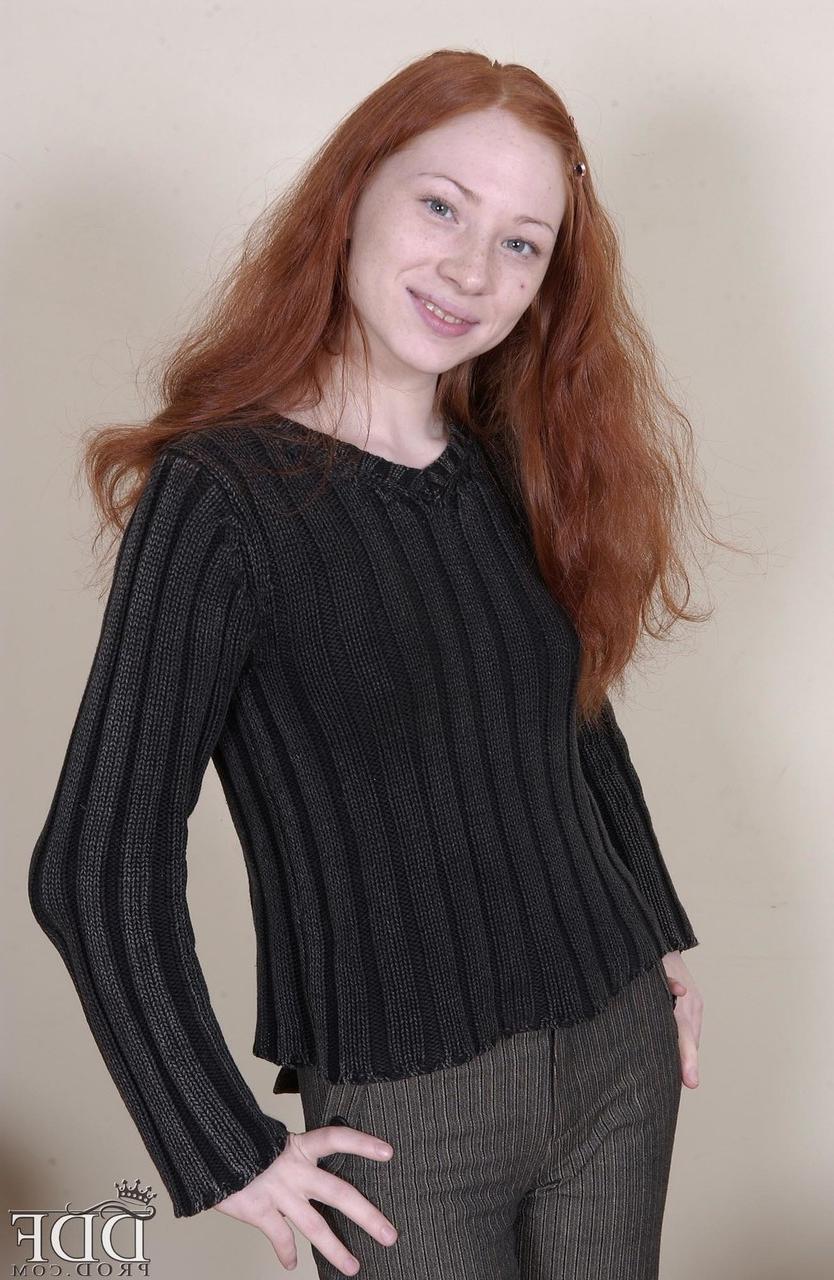 20P Redheaded American babe Millena exposes her slim body and presents her cunt
