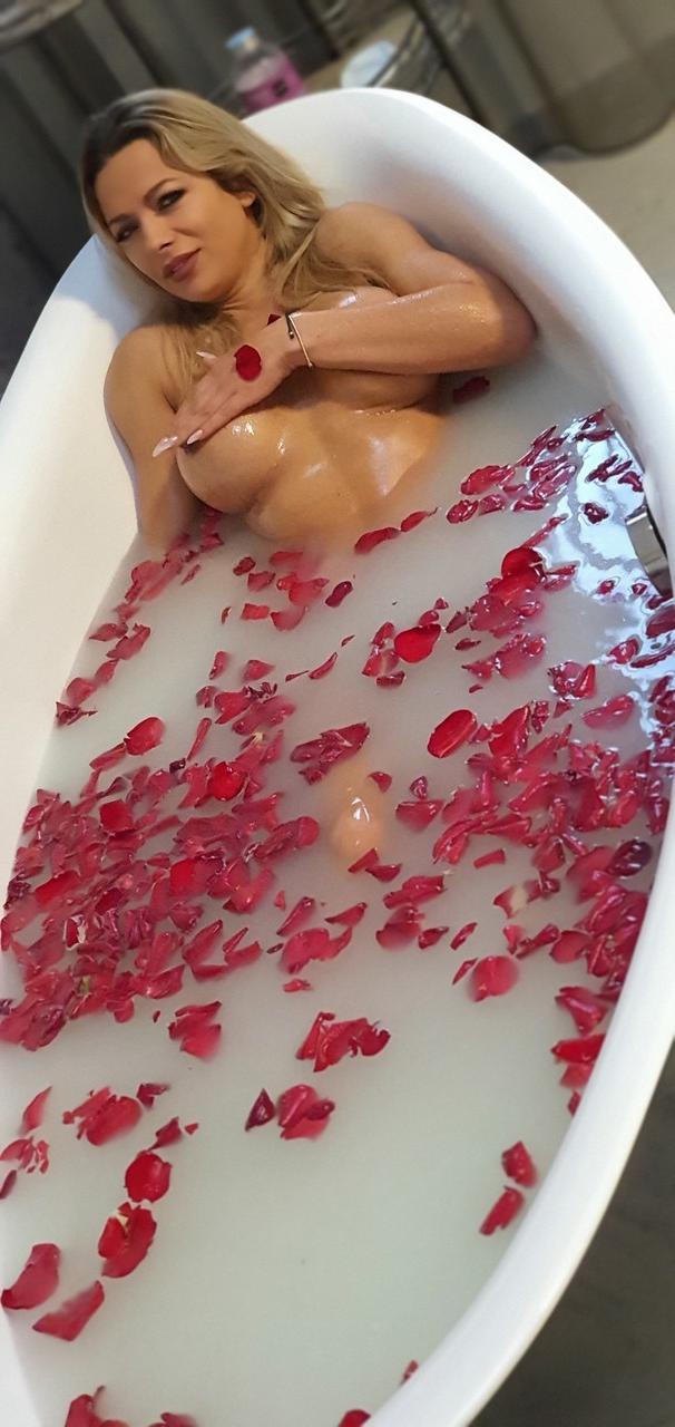 15P Hot Romanian MILF with big fakes Shalina Devine toys her twat in a tub