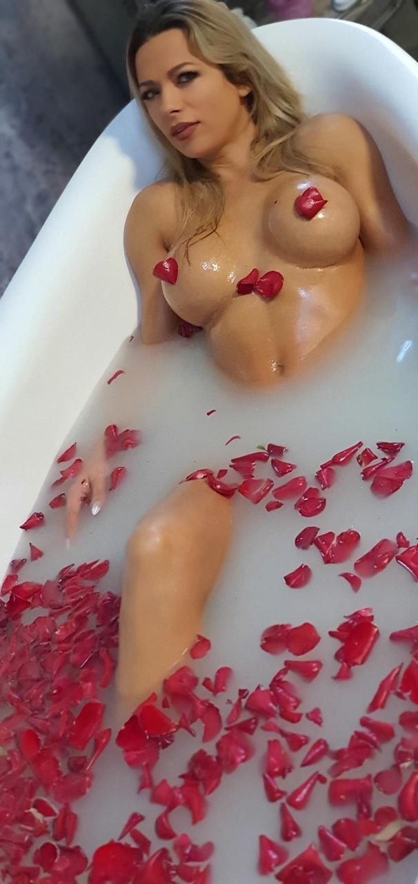 15P Hot Romanian MILF with big fakes Shalina Devine toys her twat in a tub