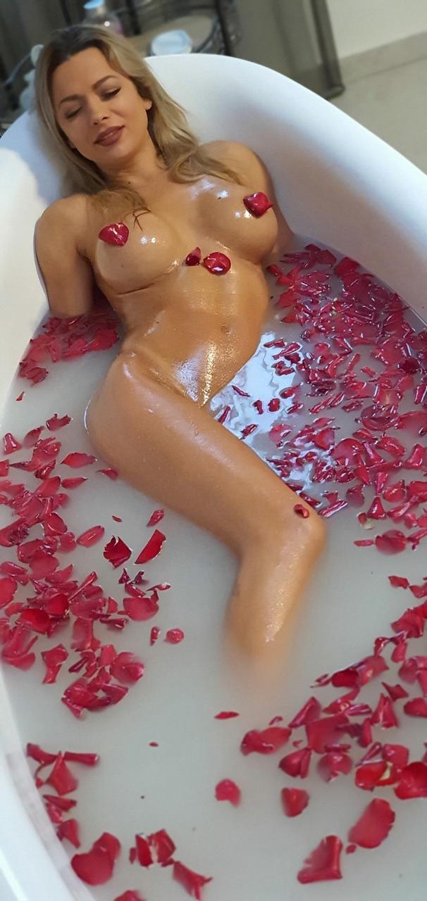 15P Hot Romanian MILF with big fakes Shalina Devine toys her twat in a tub