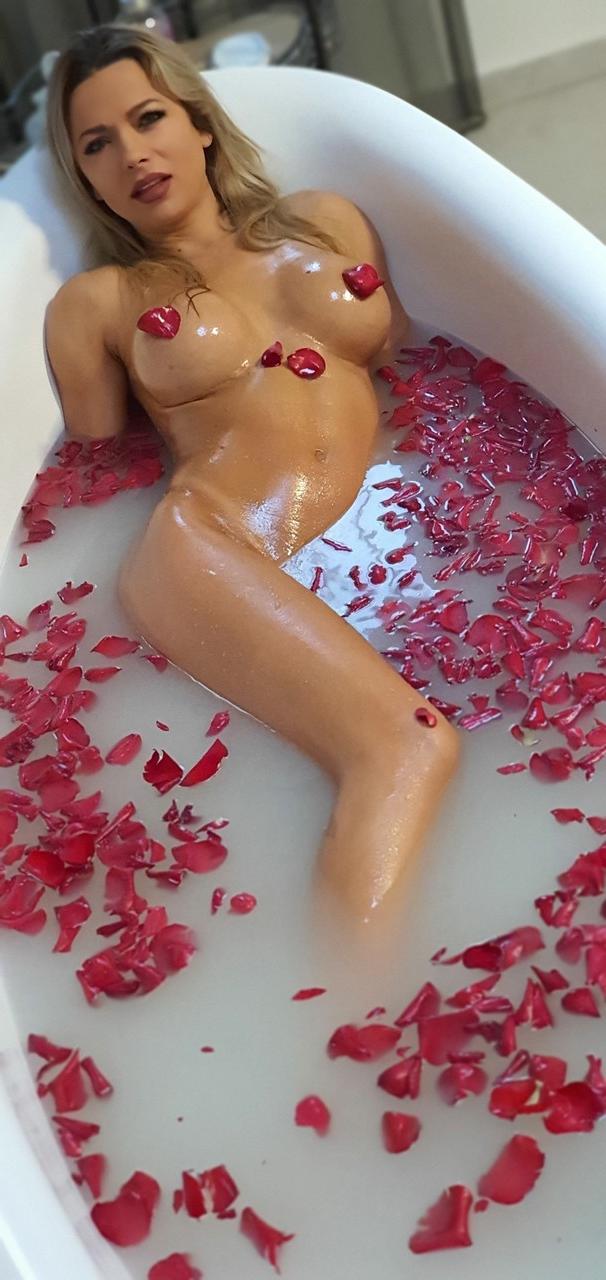 15P Hot Romanian MILF with big fakes Shalina Devine toys her twat in a tub