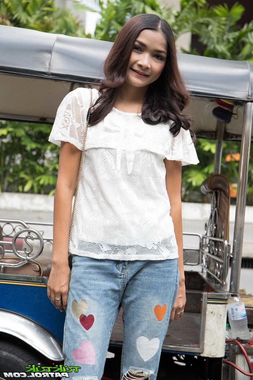 17P Asian hottie Mai is fully clothed while posing for the camera in her yard