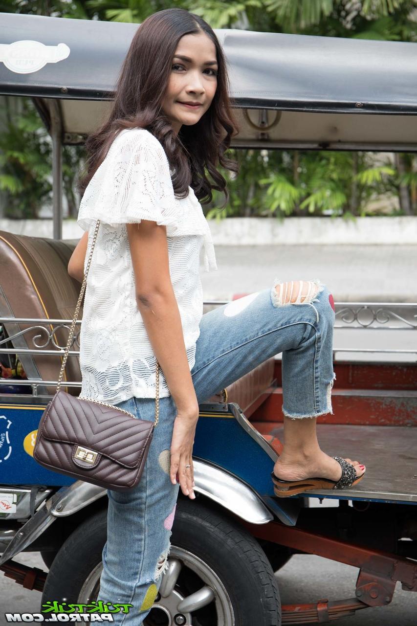 17P Asian hottie Mai is fully clothed while posing for the camera in her yard