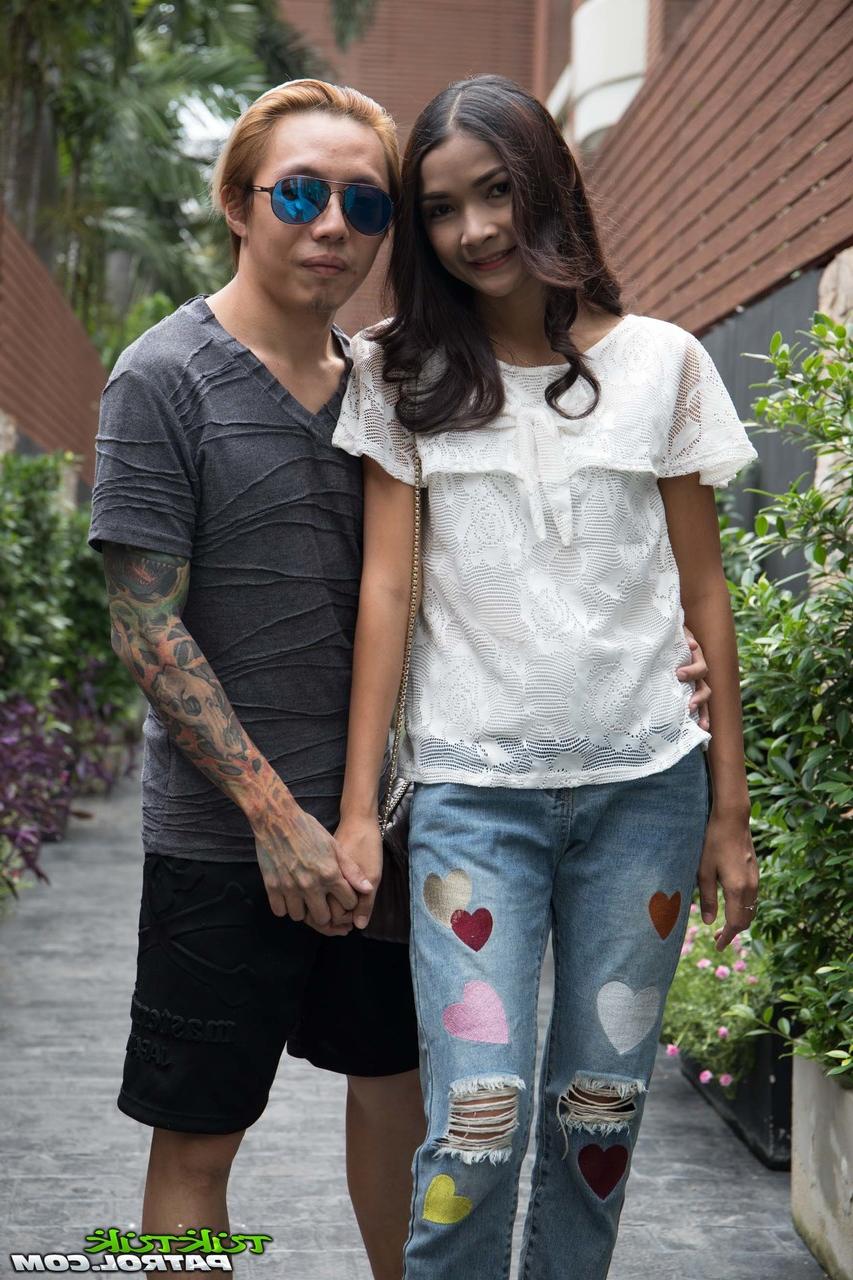 17P Asian hottie Mai is fully clothed while posing for the camera in her yard