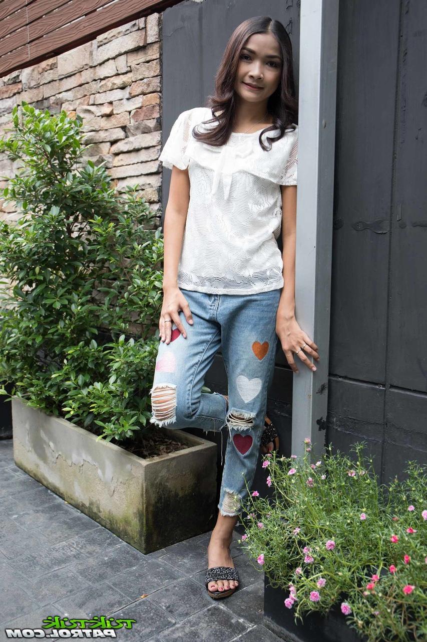 17P Asian hottie Mai is fully clothed while posing for the camera in her yard