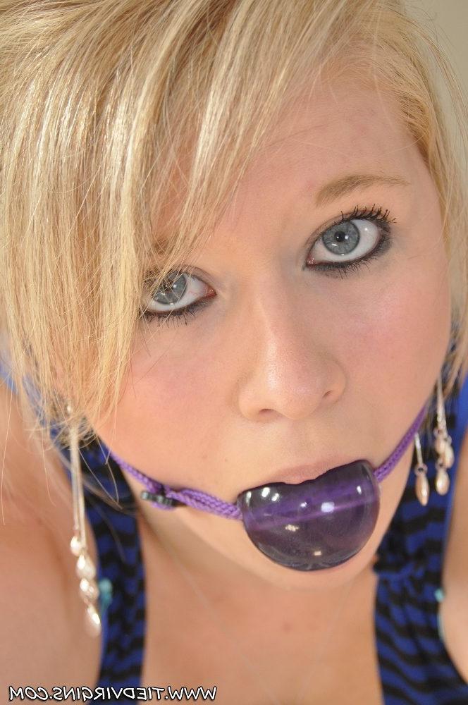 12P Blonde girl is tied to a banister while fully clothed and ball gagged