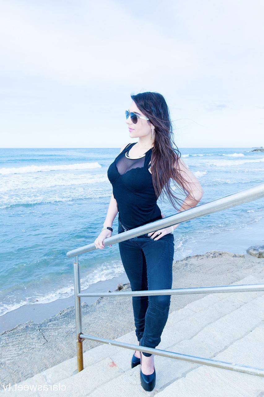15P A modelo totalmente natural Clara Sweet posando na praia com sua roupa sexy e salto alto