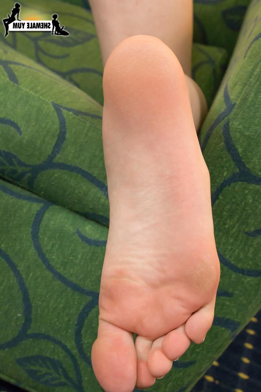 15P Dark-haired shemale Sasha Skyes displaying her sensitive feet, cock & booty