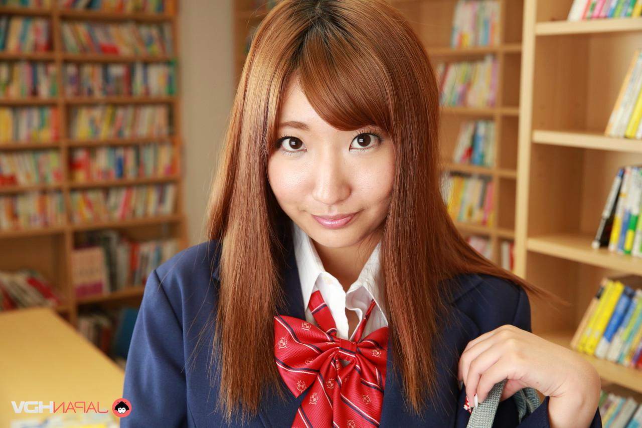 15P Redheaded Japanese coed Misaki Asuka exposes her panties and tits in a library