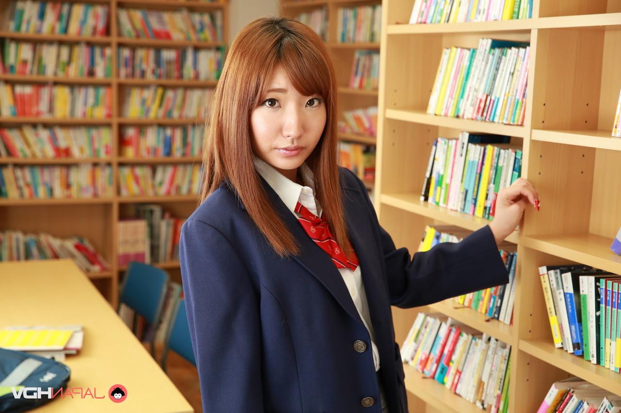 15P Redheaded Japanese coed Misaki Asuka exposes her panties and tits in a library