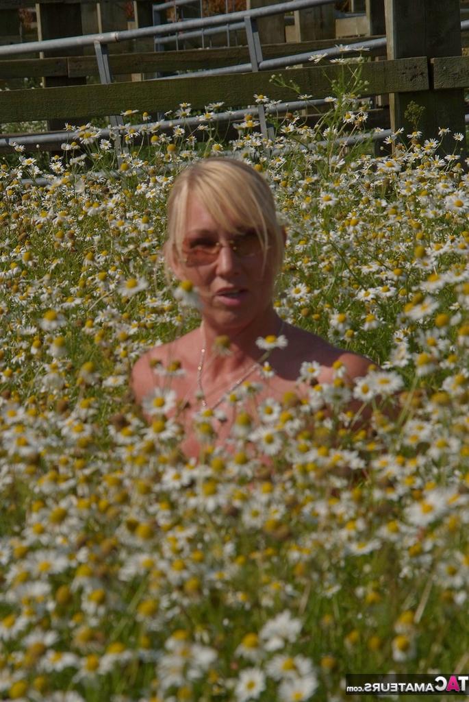 19P Die übergewichtige Blondine Melody entblößt ihre großen Brüste in einem Feld voller wilder Blumen