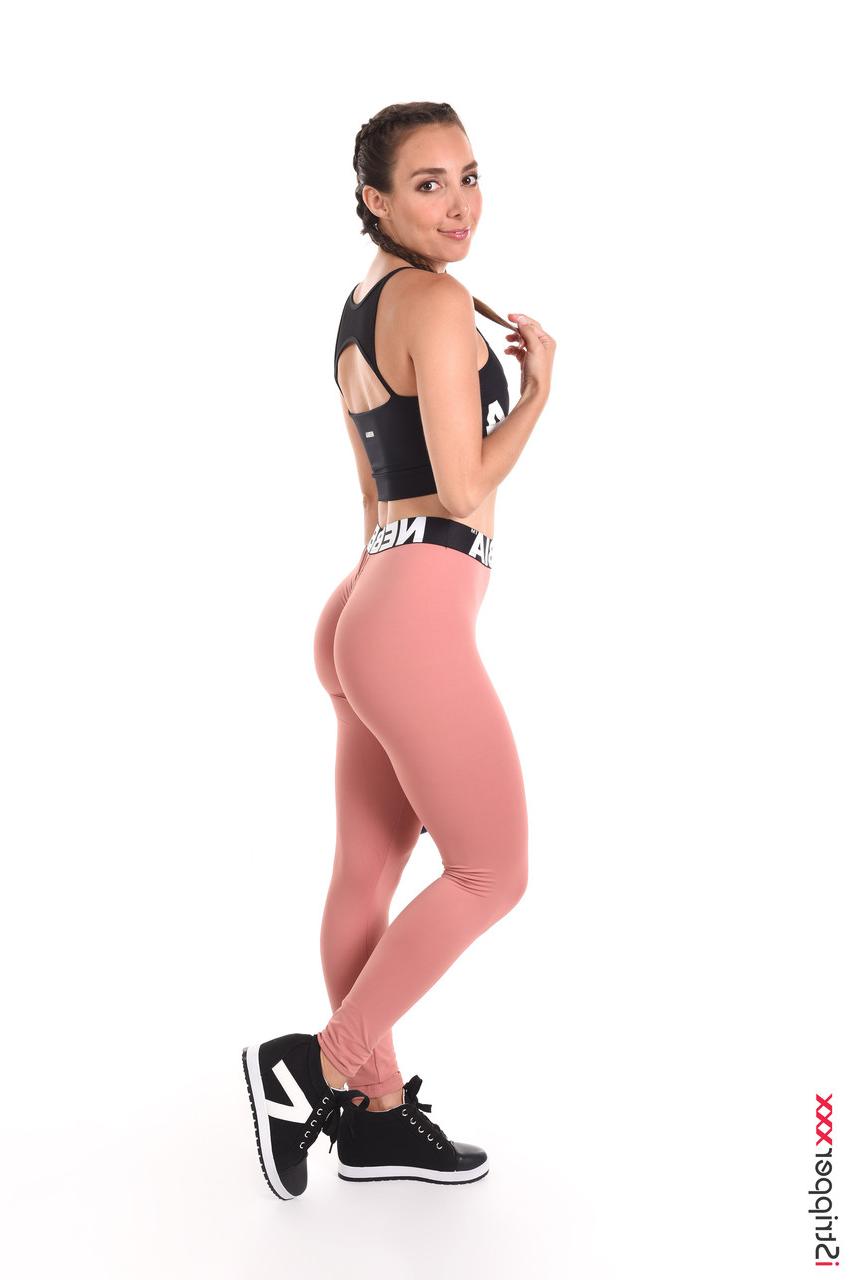 15P Sweaty brunette Ana B wets her athletic wear before masturbating in the nude
