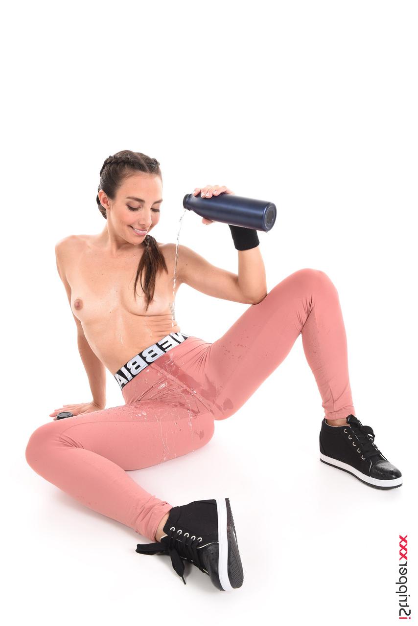 15P Sweaty brunette Ana B wets her athletic wear before masturbating in the nude