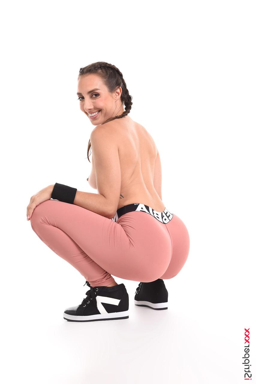 15P Sweaty brunette Ana B wets her athletic wear before masturbating in the nude