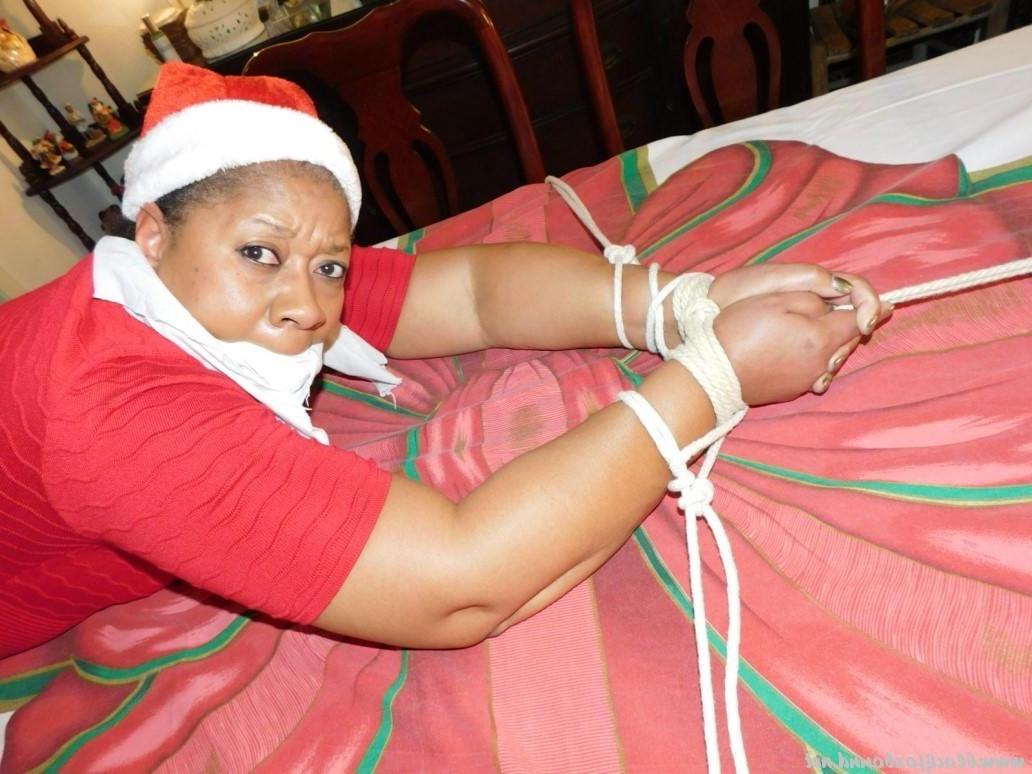 16P Ebony fatty is tied over a table at Christmas with her underwear showing