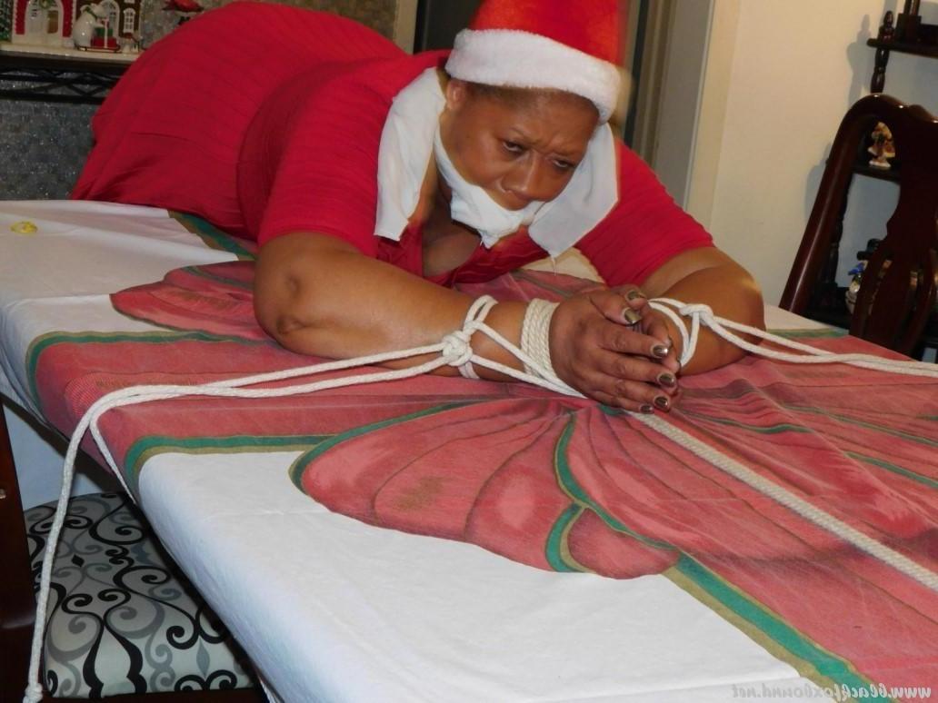 16P Ebony fatty is tied over a table at Christmas with her underwear showing