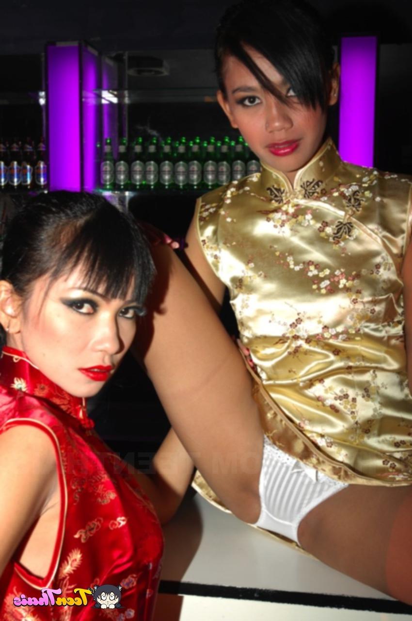 20P Thai lesbians Mintra and Sherri lose their traditional outfits & pose naked