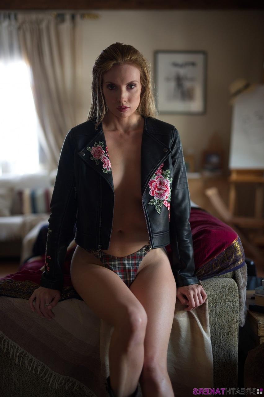 12P Glamour model Anuska bares a breast in tartan underwear and biker boots