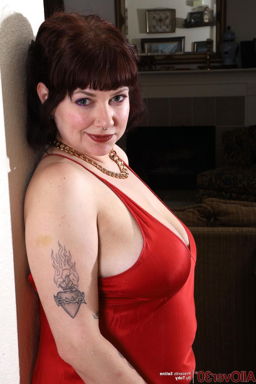 15P Over 30 plumper Satine removes a red gown while getting totally naked