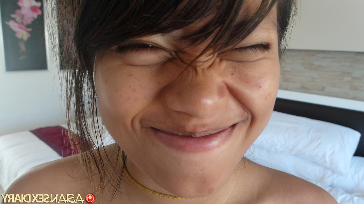 18P Beautiful Asian babe Paw shows her trimmed puffy pussy up close
