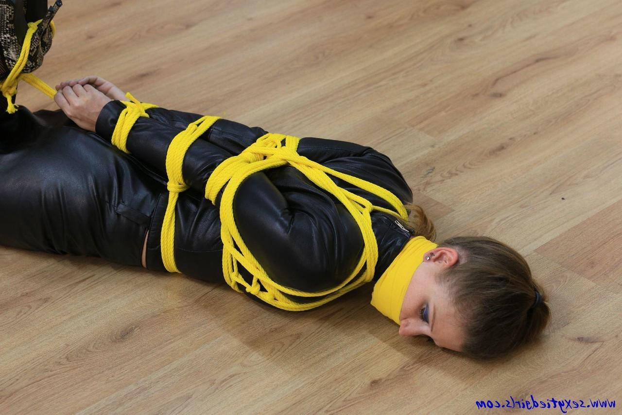 16P Caucasian girl is silenced while tied up with yellow rope in her clothing